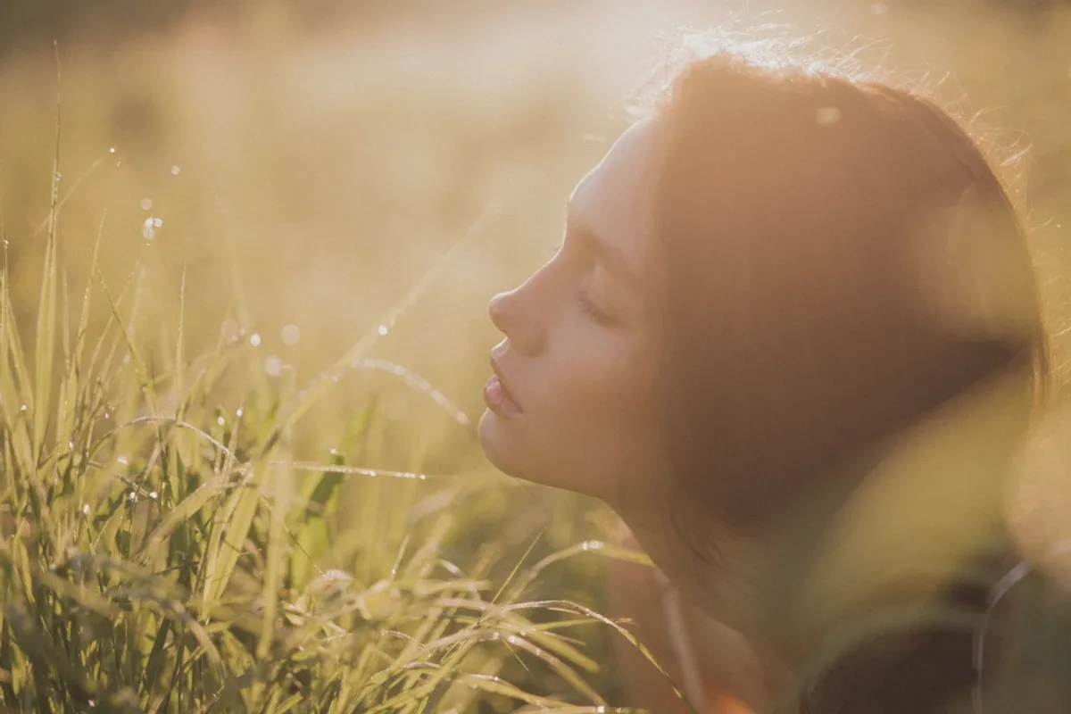 Person finding calm in a sunlit field