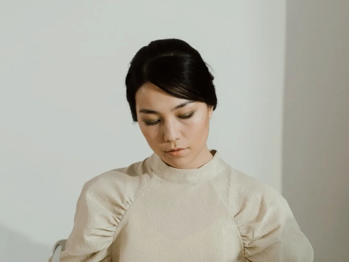 Woman sitting at a table with an empty plate