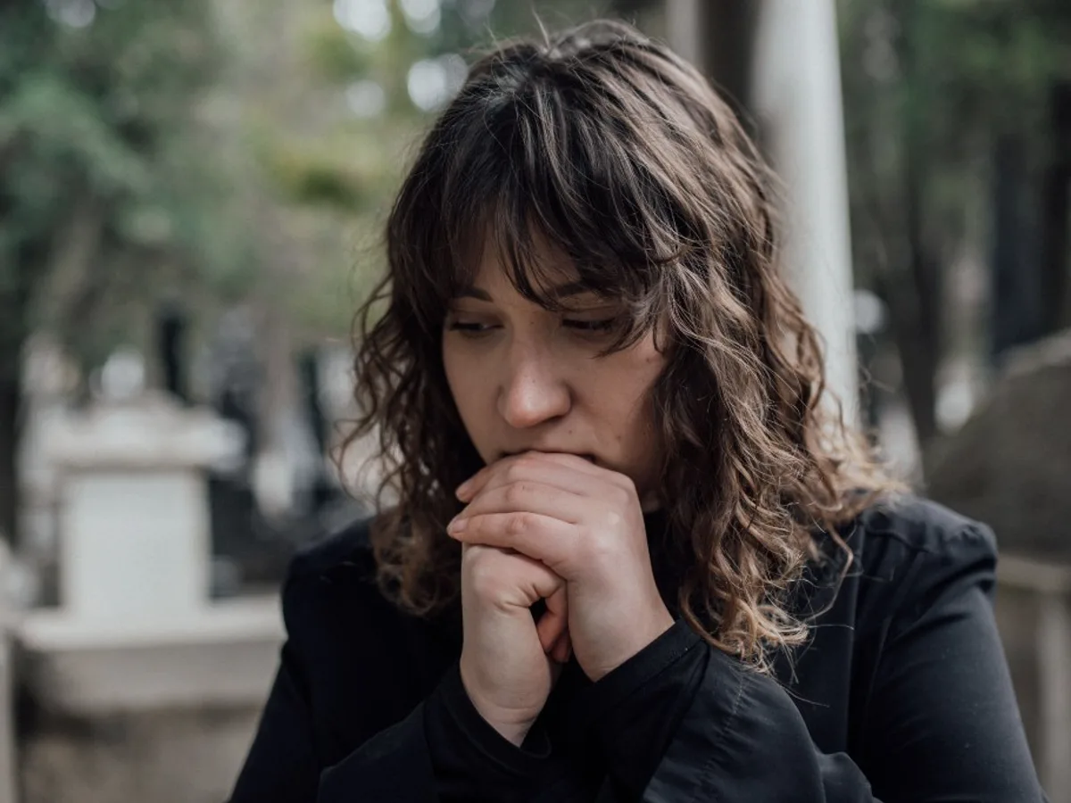 Woman in mourning at a cemetery