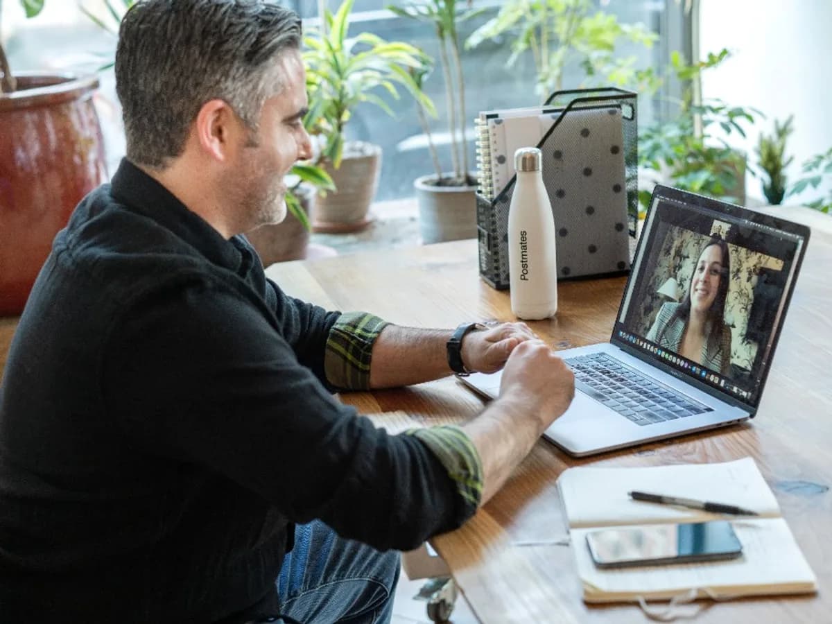 Therapist on a video call with a client via laptop